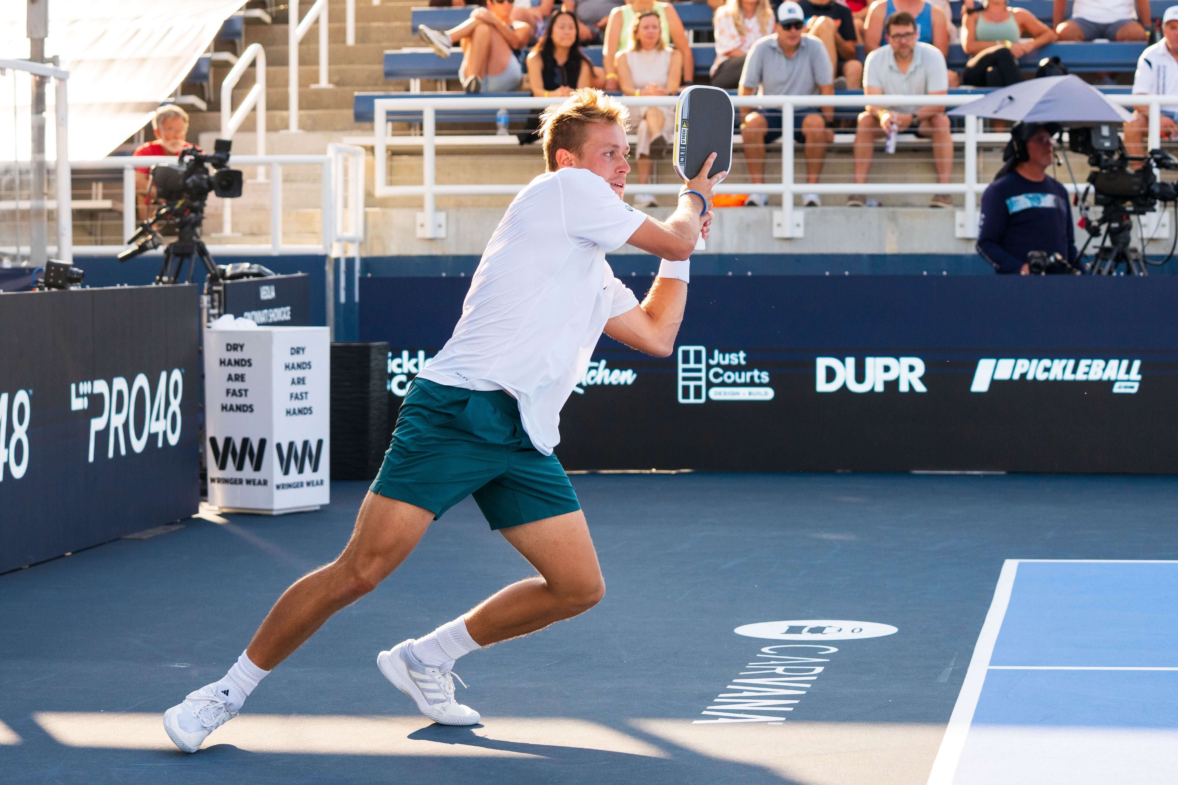 Max in white shirt and shoes and blue shorts